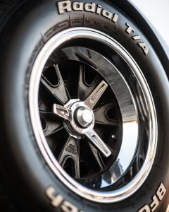 Detailed image of a Radial T/A tire and chrome wheel rim, showcasing its design and texture.