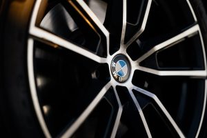Detailed view of a luxury car wheel, showcasing elegant design and craftsmanship.