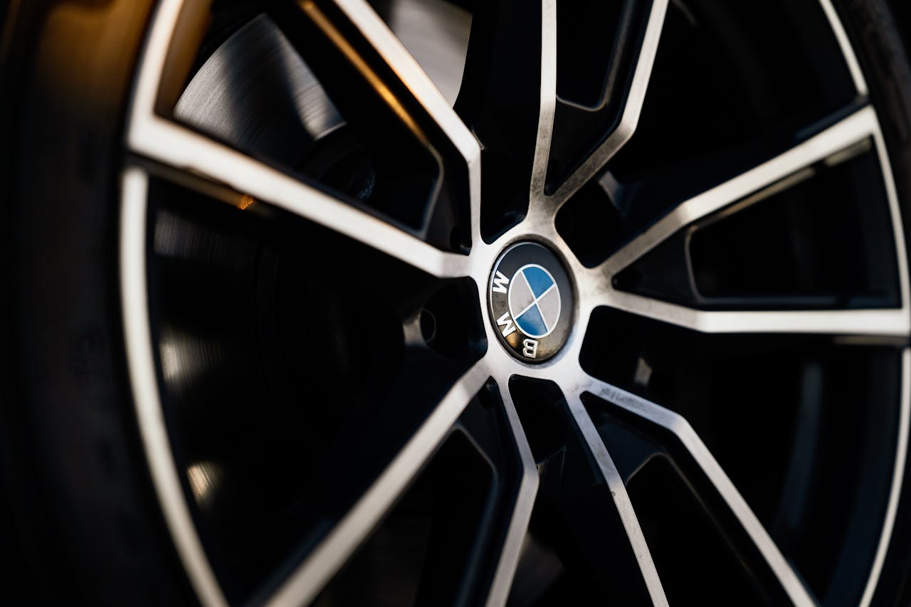 Detailed view of a luxury car wheel, showcasing elegant design and craftsmanship.